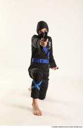 Man Young Athletic Fighting with gun Kneeling poses Casual Asian